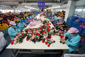 workers inspecting plush toys on a large-scale production line in a China plush toy factory